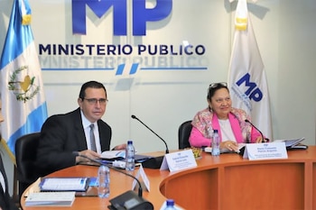 María Consuelo Porras y Gabriel García Luna sentados a una mesa con micrófonos y banderas del Ministerio Público de Guatemala detrás