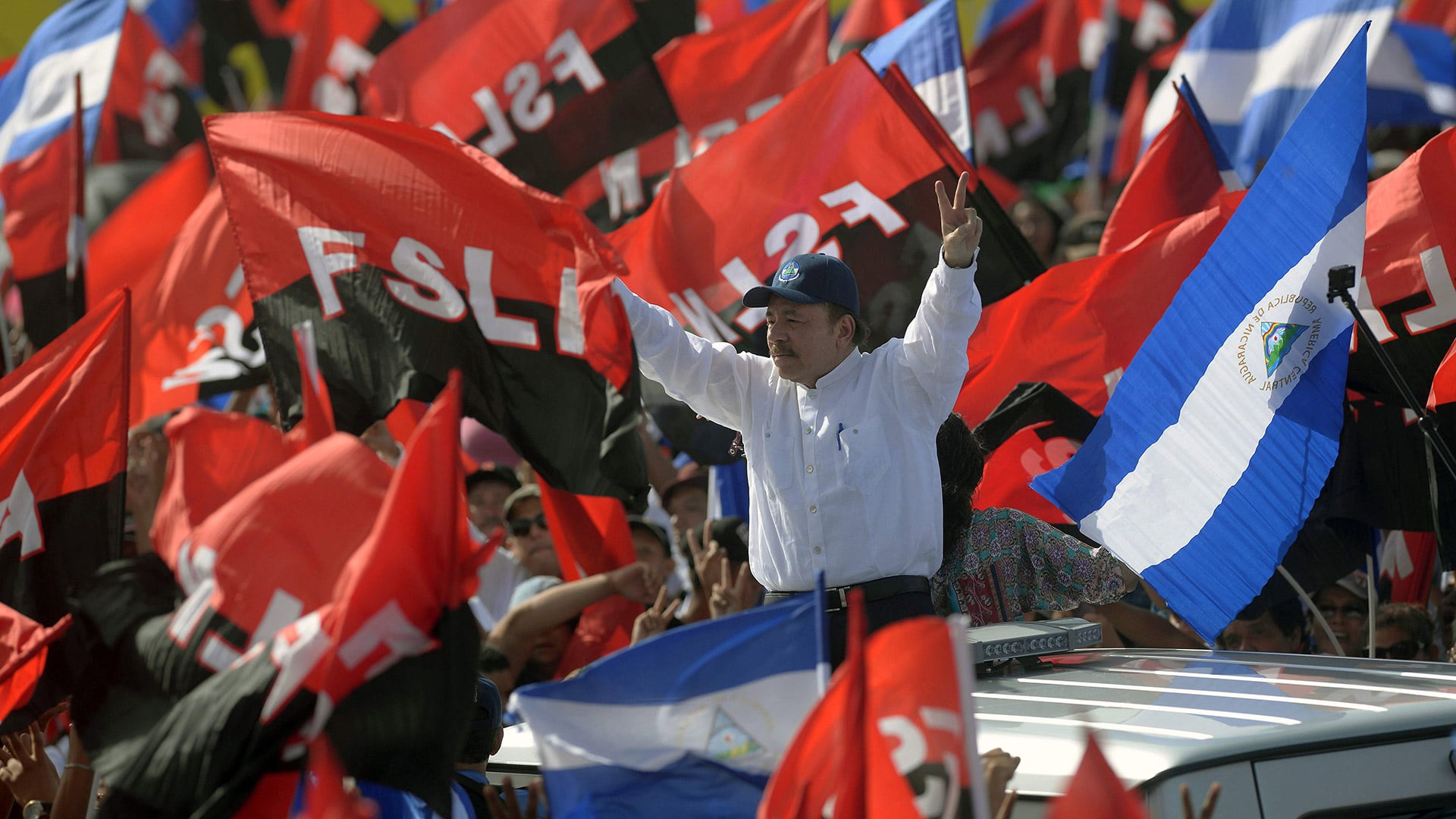 President Daniel Ortega (C), arrives to take part in the commemoration of the 39th Anniversary of the Sandinista Revolution at