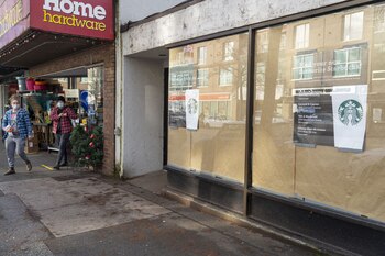Shoppers wearing protective masks exit