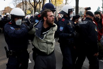 A demonstrator is detained by police officers during a protest against the coronavirus disease (COVID-19) measures in Vienna, Austria, November 20, 2021. REUTERS/Leonhard Foeger