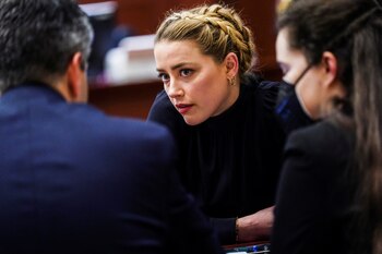 Actor Amber Heard sits with