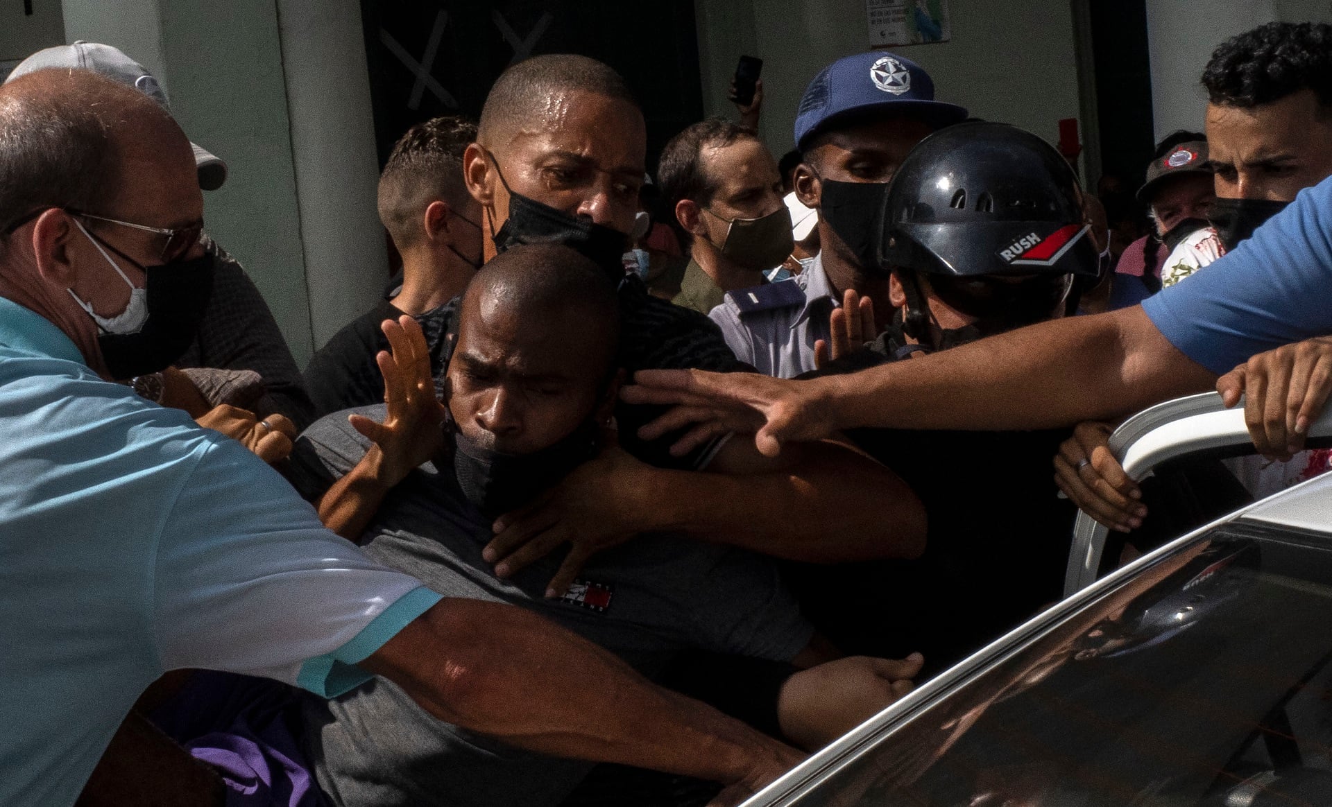 Police detain an anti-government demonstrator during a protest in Havana, Cuba, Sunday July 11, 2021. Hundreds of demonstrators went out to the streets in several cities in Cuba to protest against ongoing food shortages and high prices of foodstuffs, amid the new coronavirus crisis. (AP Photo/Ramon Espinosa)