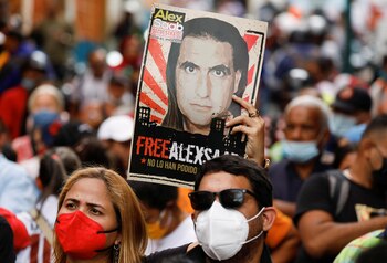 A woman holds a poster with the image of Alex Saab, a Colombian businessman with Venezuelan ties who was extradited to the U.S. on charges of money laundering, during a demonstration calling for his release, in Caracas, Venezuela April 4, 2022. REUTERS/Leonardo Fernandez Viloria