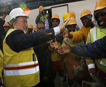 FIFA President Joseph Blatter (L) greets construction workers on September 15, 2008 as he walks through Greenpoint WC2010 football stadium in Cape Town. Blatter is on a four-day FIFA delegation to South Africa to inspect venues and meet political leaders, including former president Nelson Mandela. AFP PHOTO/GIANLUIGI GUERCIA (Photo credit should read GIANLUIGI GUERCIA/AFP/Getty Images)