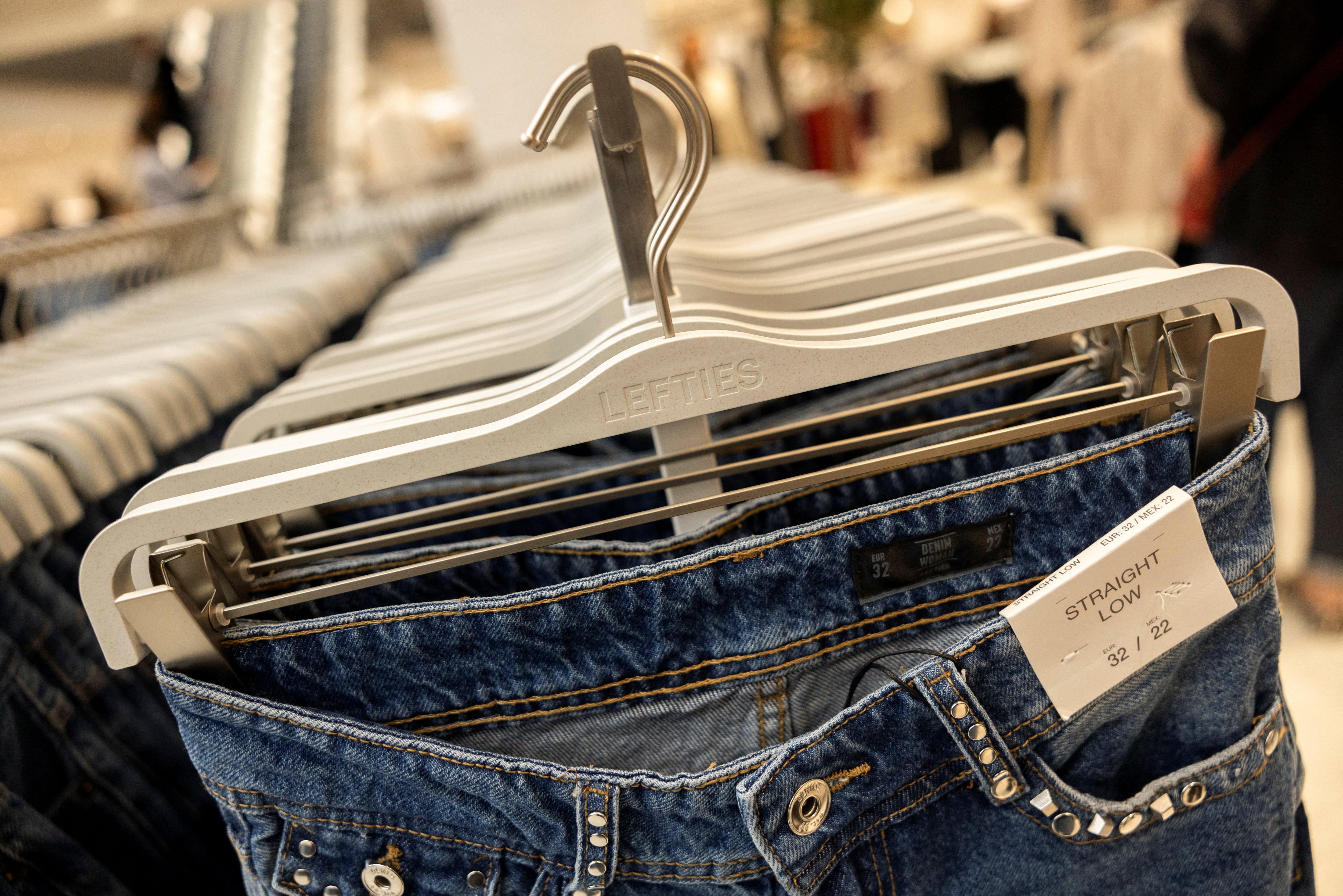 Jeans hang on display on the opening day of Lefties' first store in Britain as Inditex expands the low-cost brand internationally, in Liverpool, Britain August 27, 2026. REUTERS/Temilade Adelaja