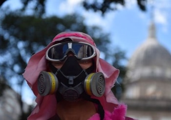 A demonstrator wears a gas