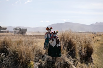 Women walk through fields and