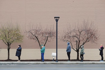 People line up at a safe social distance outside the grocery store amid the coronavirus disease (COVID-19) outbreak in Medford, Massachusetts, U.S., April 4, 2020. REUTERS/Brian Snyder