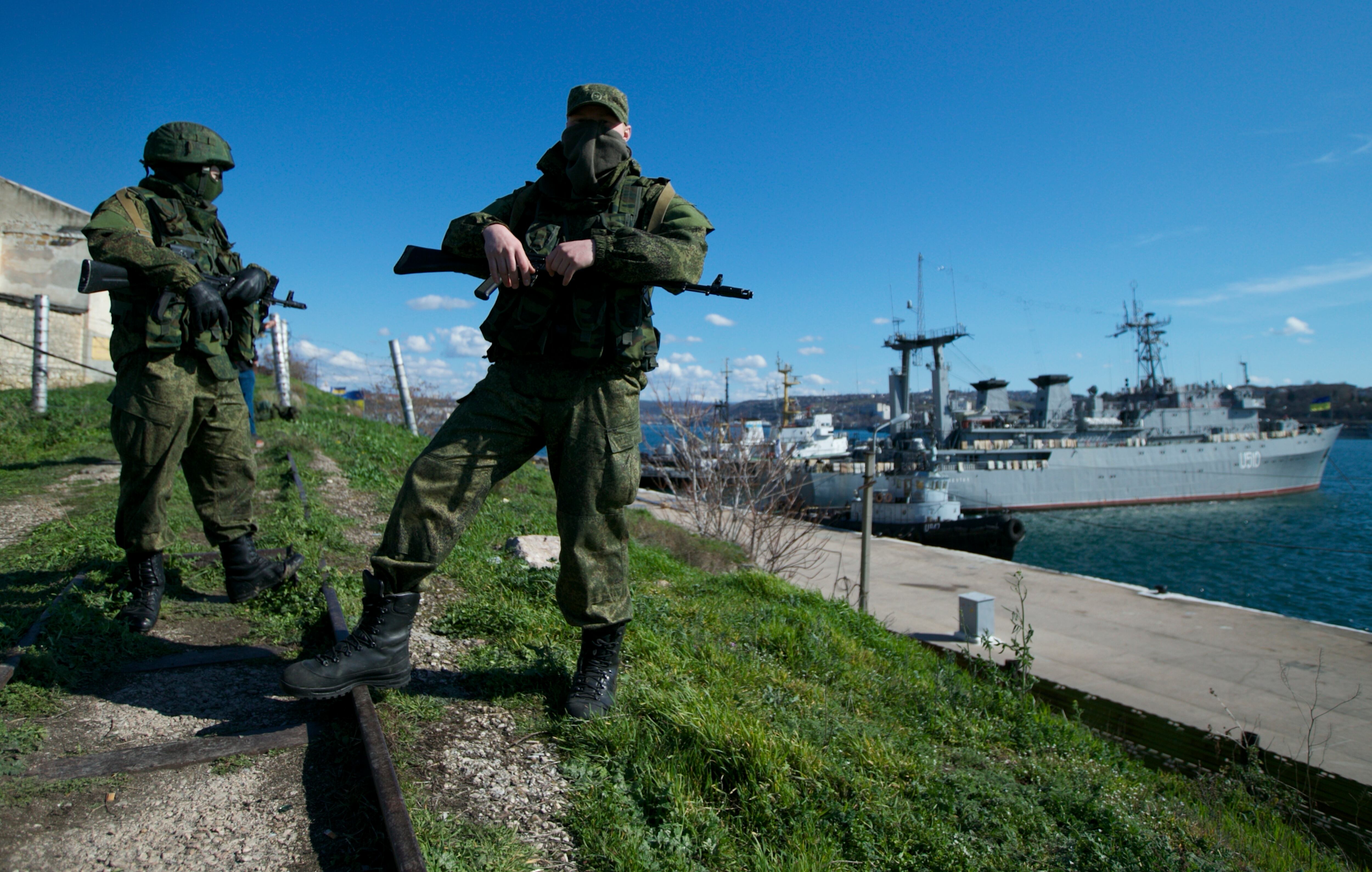 ARCHIVO - Soldados rusos montan guardia en un muelle en que dos embarcaciones navales ucranianas se encuentran atracadas, en Sebastopol, en la península de Crimea, el 5 de marzo de 2014 (AP Foto, Archivo)