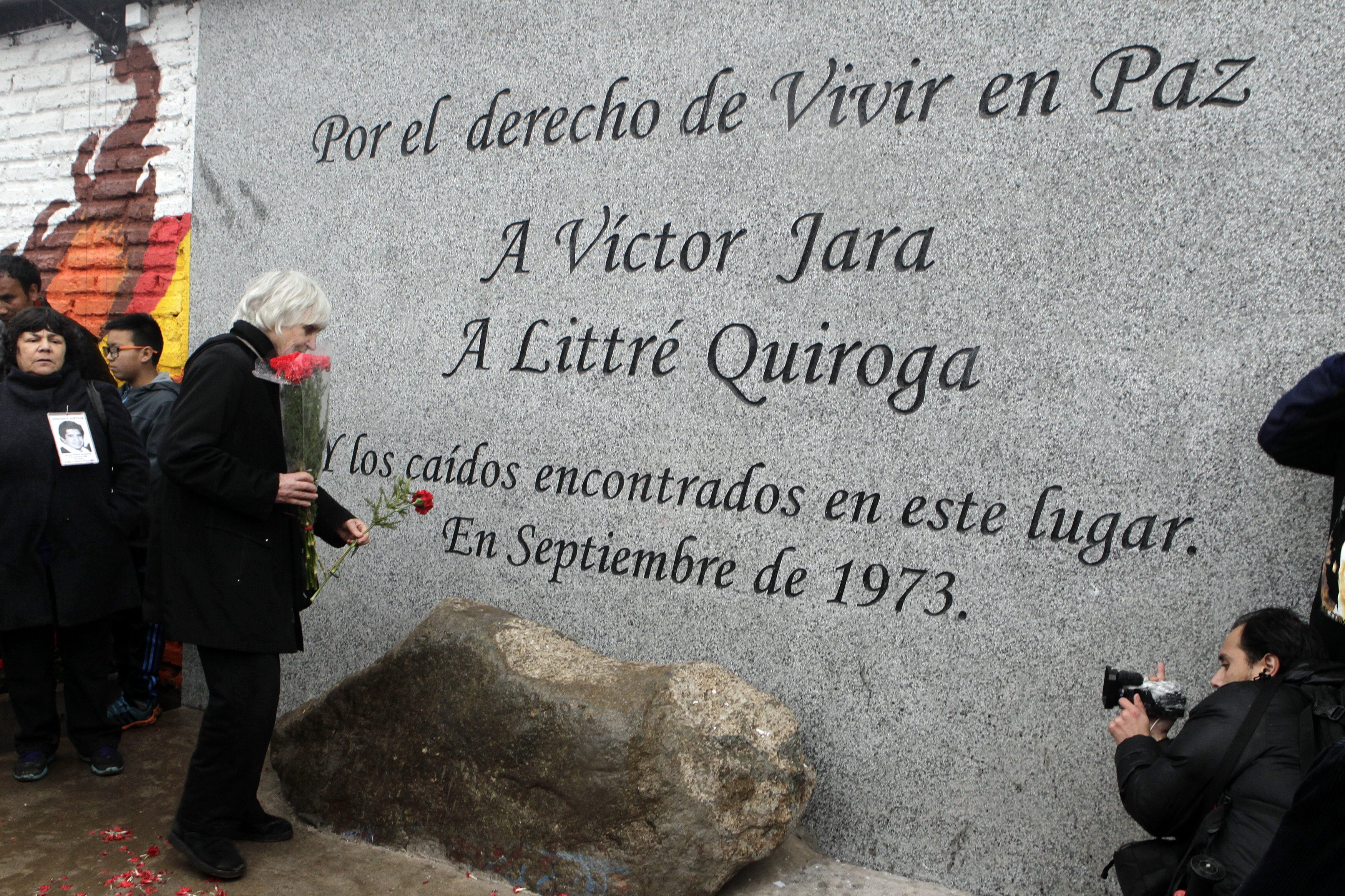La viuda de Víctor Jara, Joan Jara (c), participa en el homenaje al cantautor chileno Víctor Jara y al director de prisiones Littré Quiroga, en las afueras del Cementerio Metropolitano en Santiago (Chile), en una fotografía de archivo (EFE/Sebastián Silva)