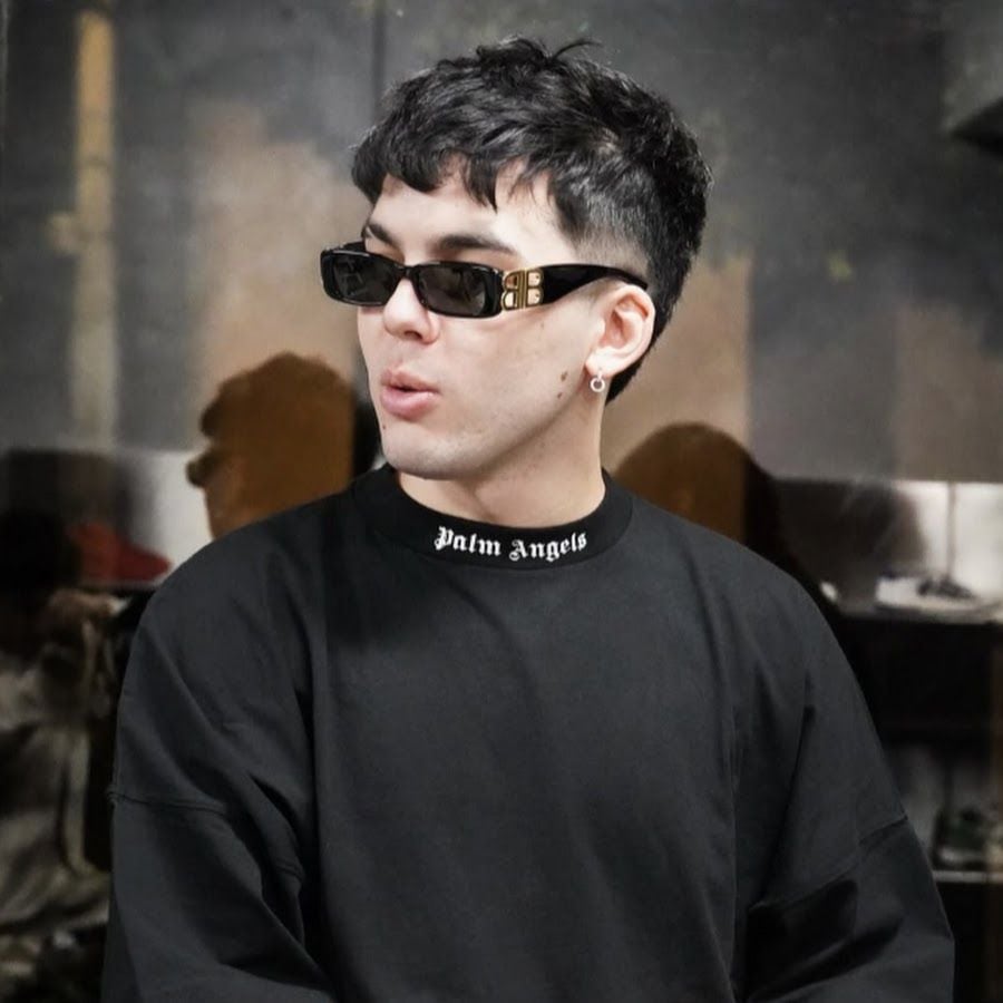 El reconocido streamer peruano Bebote posa durante un evento, mostrando su característico look con gafas de sol y sudadera negra. (Facebook)