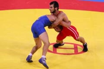 BEIJING - AUGUST 20: Ramazan Sahin of Turkey wrestles Andriy Stadnik of Ukraine for the gold medal in the 66kg Men's Freestyle wrestling event at the China Agriculture University Gymnasium during Day 12 of the Beijing 2008 Olympic Games on August 20, 2008 in Beijing, China. (Photo by Al Bello/Getty Images)