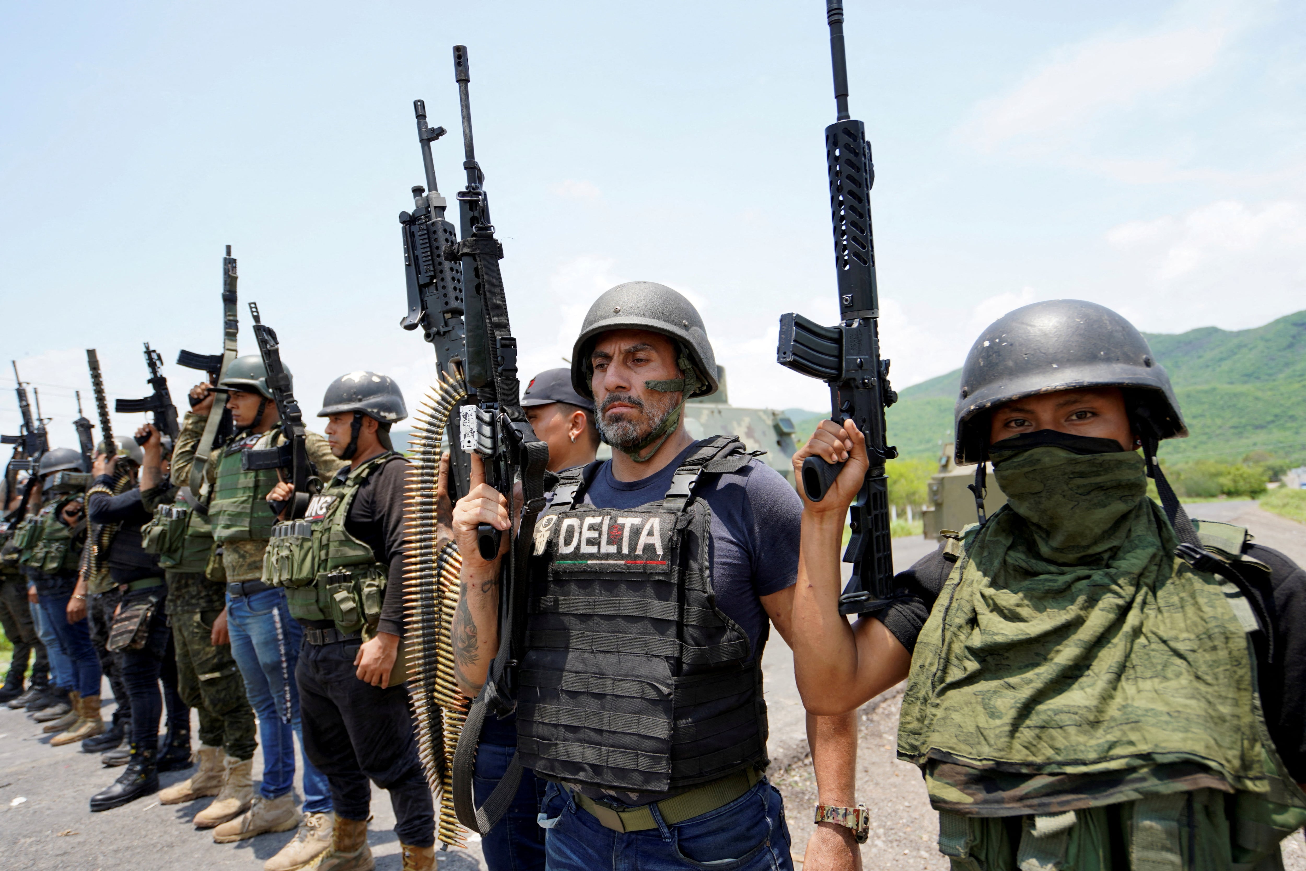 FILE PHOTO: Members of the Jalisco New Generation Cartel (CJNG), led by Nemesio Oseguera, known as “El Mencho,” pose for a photo at an undisclosed location in Michoacan state, Mexico, July 1, 2021. REUTERS/Stringer/File Photo