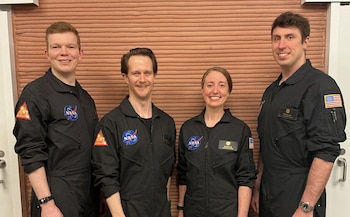 Members of NASA’s CHAPEA (Crew Health and Performance Exploration Analog) Mission 2 crew stands in their workspace after spending a year in their isolated and confined habitat at NASA’s Johnson Space Center in Houston. (from left: James Spicer, Matthew Montgomery, Ellen Ellis, and Ross Elder).