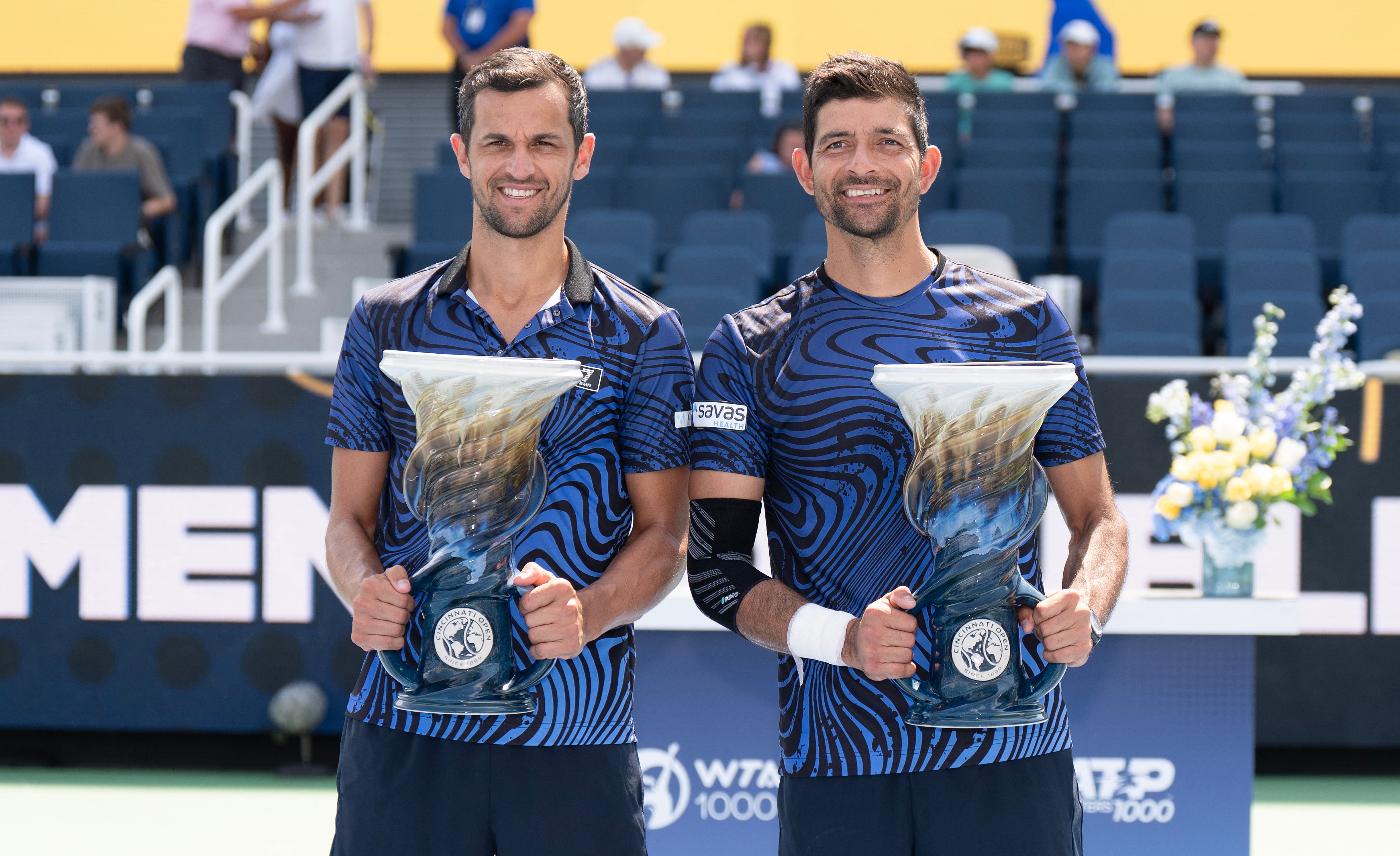 Aug 19 2024; Cincinnati, OH, USA; Marcelo Arevalo of El Salvador and Mate Pavic of Croatia pose with the trophy after winning the men’s doubles final against Mackenzie Mcdonald of the United States and Alex Michelsen of the United States on day seven of the Cincinnati Open. Mandatory Credit: Susan Mullane-USA TODAY Sports