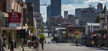 Commercial office buildings, including the Transnet SOC Ltd. headquarters office, left, stand on the skyline in the the Central Business District (CBD) of Johannesburg.