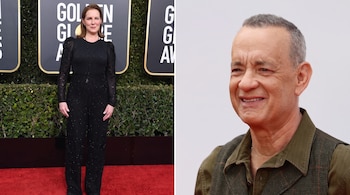 Composición con Elizabeth Perkins vestida de negro sobre una alfombra roja a la izquierda y Tom Hanks sonriente a la derecha.