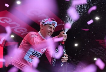 El ciclista esloveno Tadej Pogacar, del UAE Team Emirates, celebra en el podio con la maglia rosa tras ganar la segunda etapa del Giro de Italia, entre San Francesco al Campo y el santuario de Oropa, Italia - crédito Jennifer Lorenzini/REUTERS