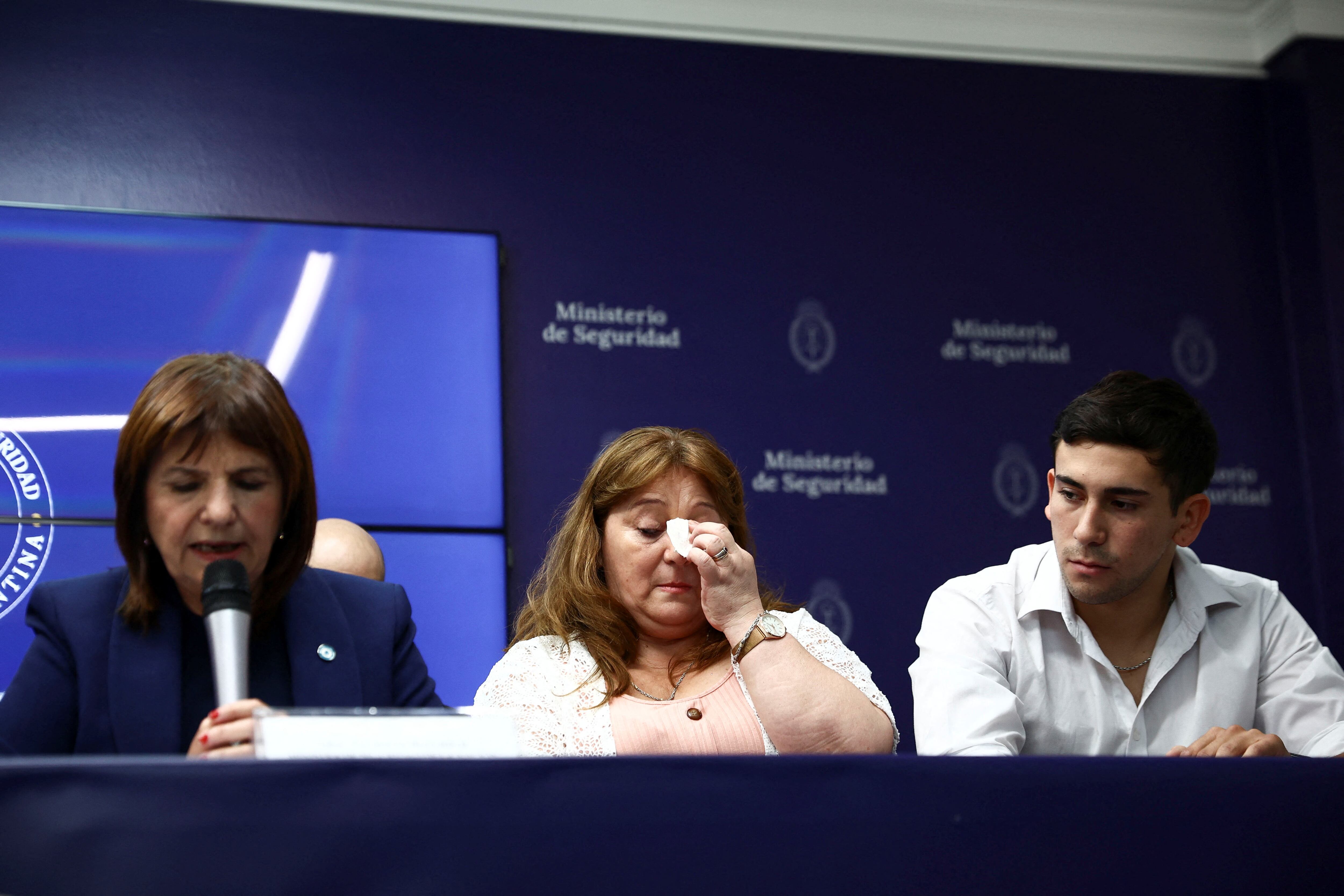 Griselda Heredia, mother of Nahuel Agustin Gallo reacts next to her son, Kevin Gallo as Argentina's Security Minister Patricia Bullrich speaks at a news conference regarding Nahuel Agustin Gallo, a non-commissioned officer of Argentina's Gendarmeria detained after attempting to enter Venezuela irregularly earlier this month and under investigation for links to international right-wing terrorism, Venezuela's attorney general Tarek Saab said in a statement on Friday, in Buenos Aires, Argentina, December 27, 2024. REUTERS/ Tomas Cuesta