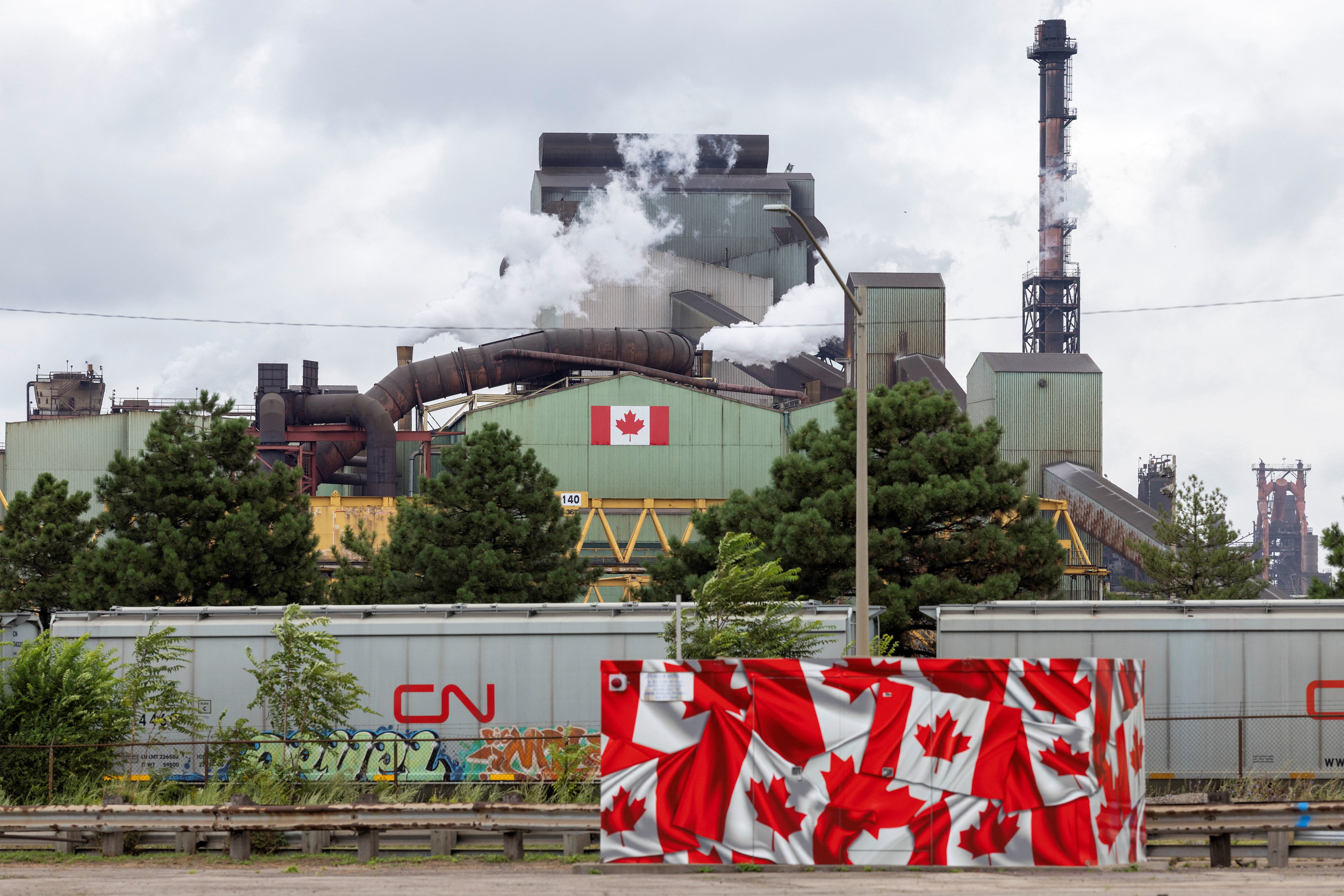 Las banderas adornan la planta siderúrgica de ArcelorMittal Dofasco mientras se intensifican las tensiones comerciales por los aranceles de EE. UU. y las medidas de represalia de Canadá, en Hamilton (Ontario, Canadá), el 24 de agosto de 2026. REUTERS/Carlos Osorio