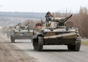 Service members of pro-Russian troops drive armoured vehicles during Ukraine-Russia conflict on a road outside the southern port city of Mariupol, Ukraine April 10, 2022. REUTERS/Alexander Ermochenko