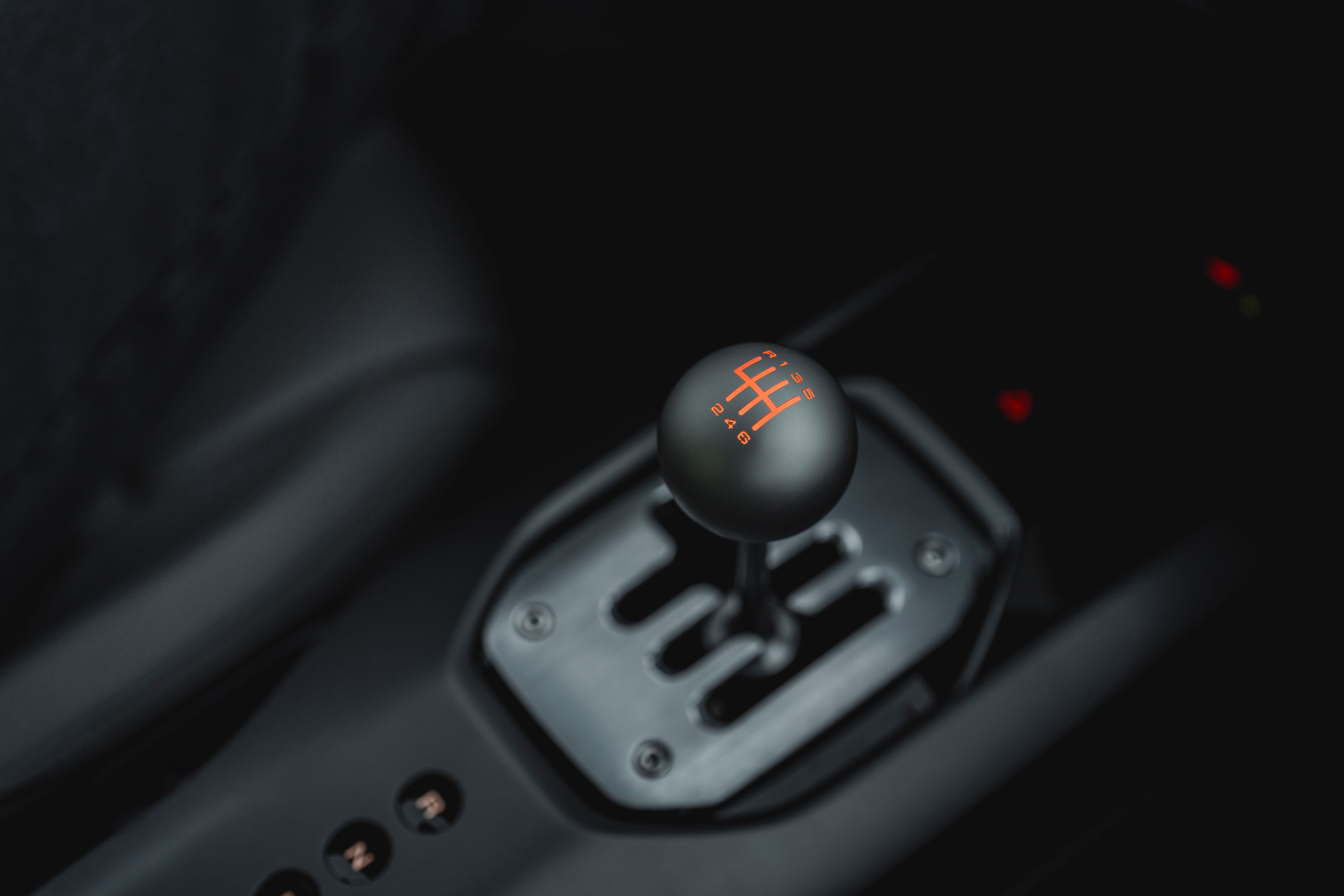 El interior del Ferrari 12Cilindri manual muestra su palanca de cambios con el esquema de marchas grabado en naranja, un componente que apela a la tradición de la marca. (Ferrari)