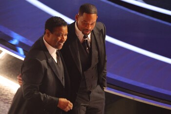 Denzel Washington (L) walks with