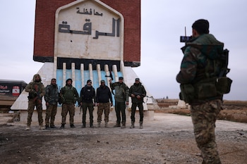 Soldados del gobierno sirio posan