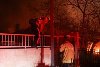 Firefighters work as powerful winds