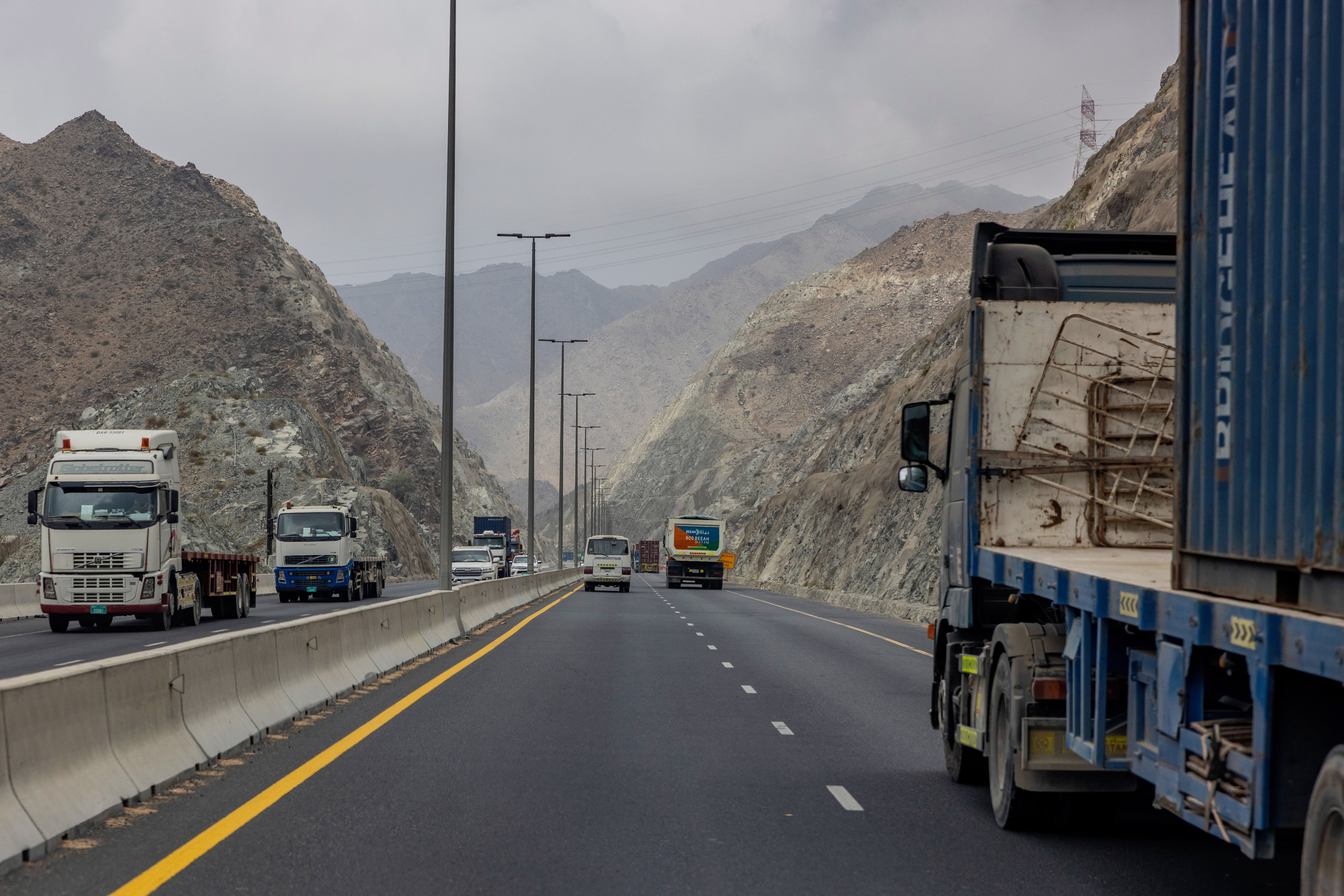 Camiones circulan el jueves en la zona portuaria de Khorfakkan, en los Emiratos Árabes Unidos. (Katarina Premfors/Para The Washington Post) (Katarina Premfors/For The Washington Post)