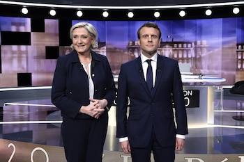 FILE PHOTO: Candidates for the 2017 presidential election, Emmanuel Macron (R), head of the political movement En Marche !, or Onwards !, and Marine Le Pen, of the French National Front (FN) party, pose prior to the start of a live prime-time debate in the studios of French television station France 2, and French private station TF1 in La Plaine-Saint-Denis, near Paris, France, May 3, 2017. REUTERS/Eric Feferberg/Pool/File Photo