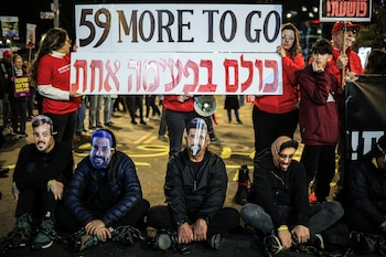 Manifestantes encadenados con máscaras que
