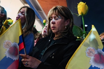 A woman reacts as she