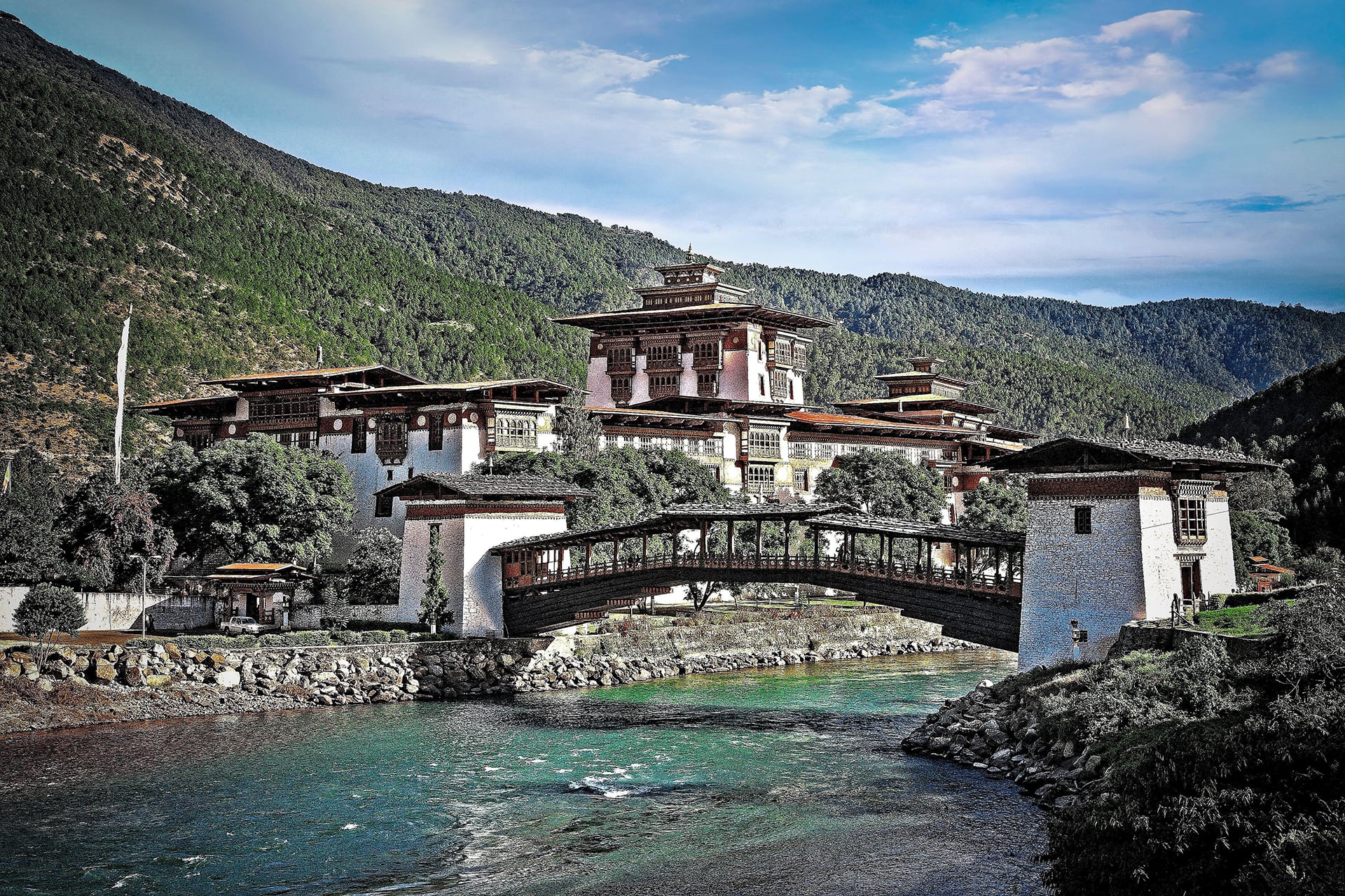 El Valle de Punakha en Bután disfruta de clima templado en el Himalaya y su puente colgante permite cruzar entre campos de arroz y banderas de oración (Grosby Group)