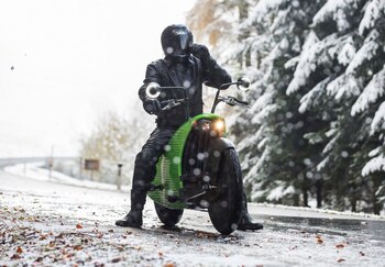 A rider adjusts his helmet