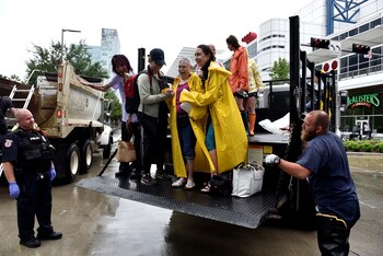 Las autoridades ayudan a unas mujeres a evacuar sus hogares (Reuters)