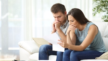 Worried couple reading an important