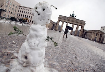 Un muñeco de nieve en a Puerta de Brandenburgo en Berlín el 16 de enero de 2018 (AFP)