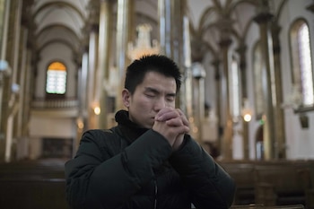 Un hombre rezando en Wangfujing