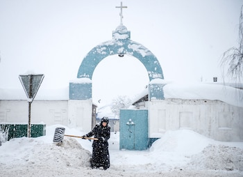 Una monja barre la nieve