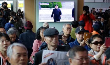 Decenas de personas en la estación de trenes de Seúl observan el encuentro. (AP Photo/Ahn Young-joon)