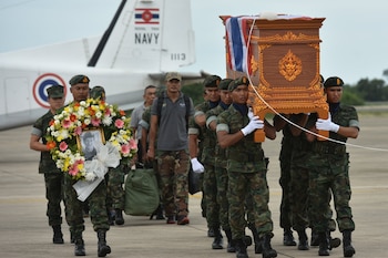 An honour guard carries the