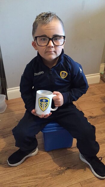 Con su taza del Leeds,