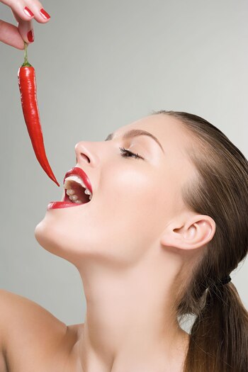 Woman holding a red chili