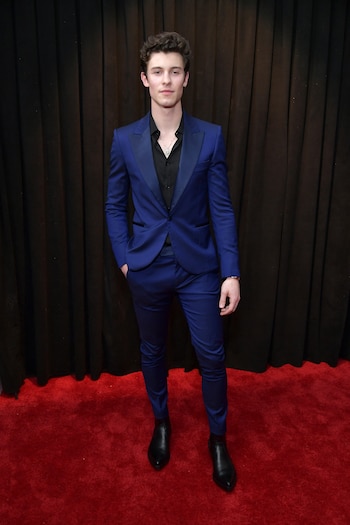 Shawn Mendes asistió a la ceremonia de los premios Grammy con un esmoquin achupinado en azul francia con camisa negra. Completó el look con botas de cuero en punta