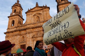 Una mujer sostiene un cartel