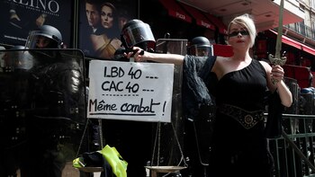 Una manifestante sostiene una balanza