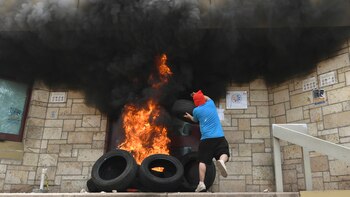 Un encapuchado atacando la embajada