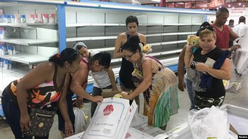 Cubanos compran pollo en un