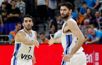 Facundo Campazzo choca las manos con Patricio Garino